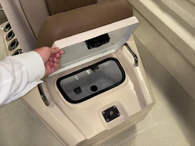 Slide: The Image of 2025 Xpress H22 Bay boat storage compartment with open lid, showcasing interior details. - 19