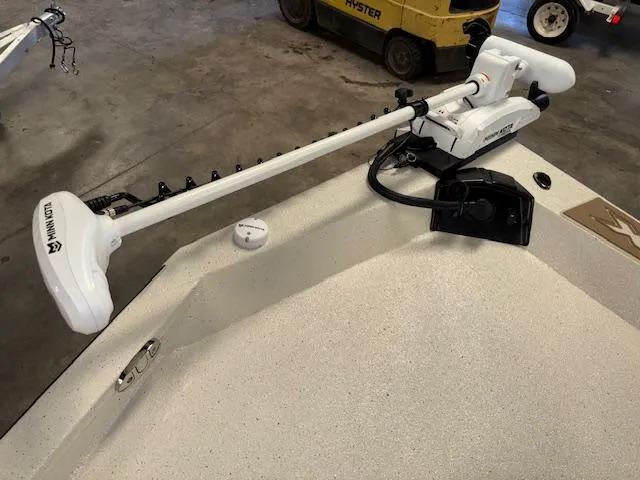 Slide: The Image of 2025 Xpress H22 Bay boat with Minn Kota trolling motor in a garage setting. - 22
