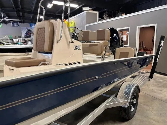 Slide: The Image of 2025 Xpress H22 Bay boat in showroom, featuring sleek design and comfortable seating. - 4