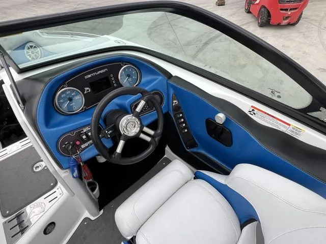 Slide: The Image of 2014 Centurion Enzo SS210 boat cockpit with blue dashboard and steering wheel. - 10