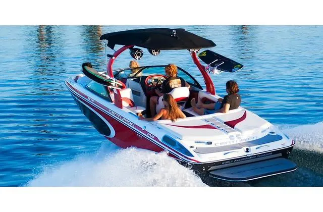 Slide: The Image of 2014 Centurion Enzo SS210 boat cruising on water with passengers enjoying the ride. - 2