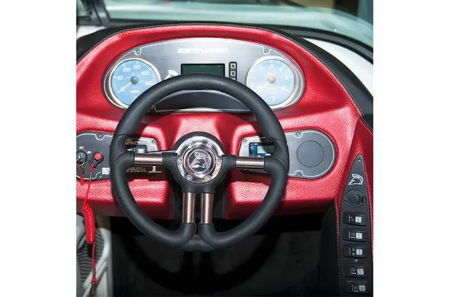 Slide: The Image of Dashboard of 2014 Centurion Enzo SS210 boat with red accents and steering wheel. - 5
