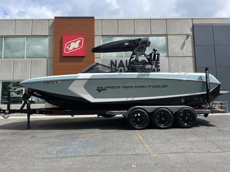 Slide: The Image of 2019 Nautique Super Air Nautique G25 boat on trailer, parked outside dealership. - 1