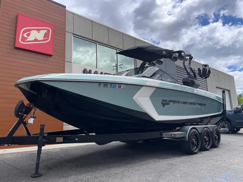 Slide: The Image of 2019 Nautique Super Air Nautique G25 boat on trailer outside dealership. - 2
