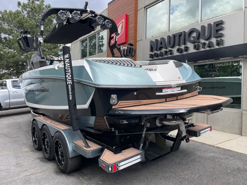 Slide: The Image of 2019 Nautique Super Air Nautique G25 boat on trailer outside dealership. - 3