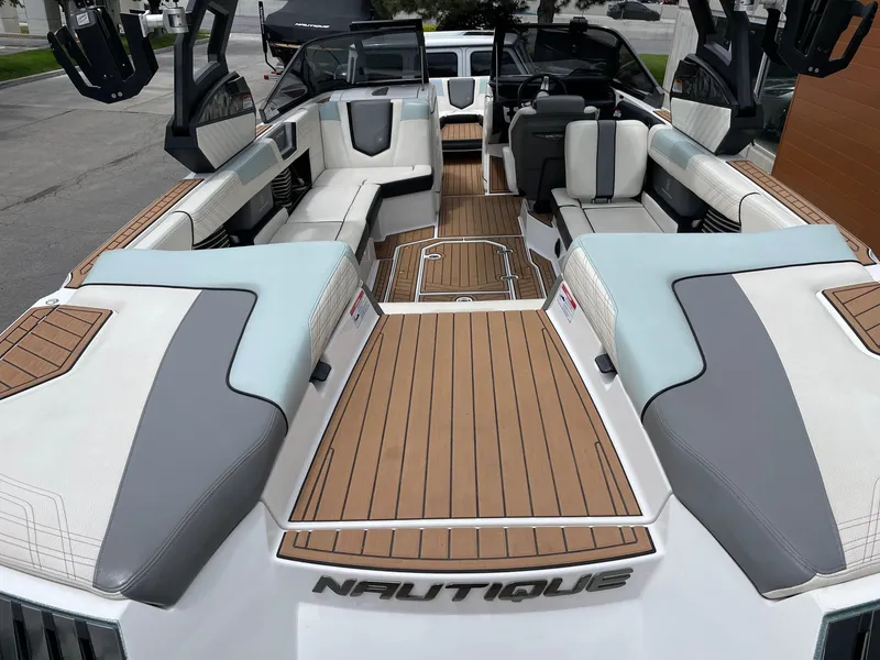 Slide: The Image of 2019 Nautique Super Air Nautique G25 interior with luxurious seating and teak flooring. - 4