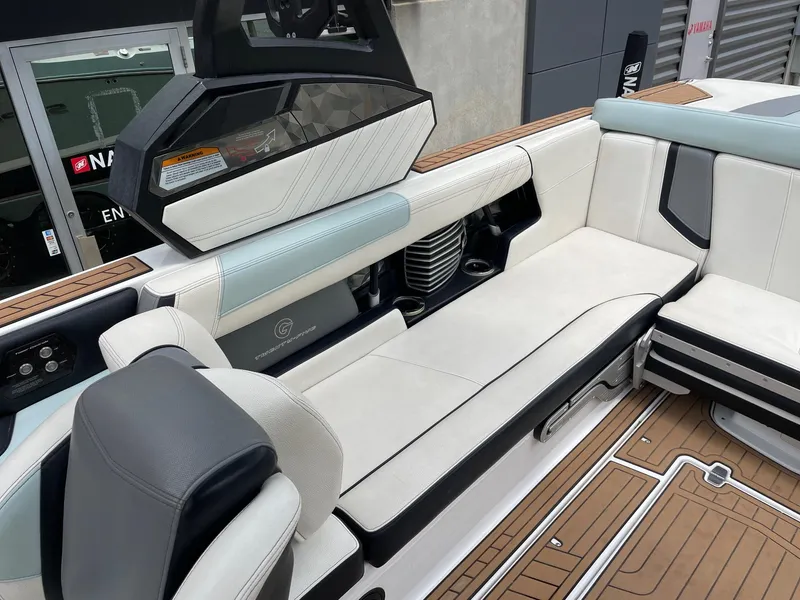 Slide: The Image of 2019 Nautique Super Air Nautique G25 interior with white seating and teak flooring. - 8