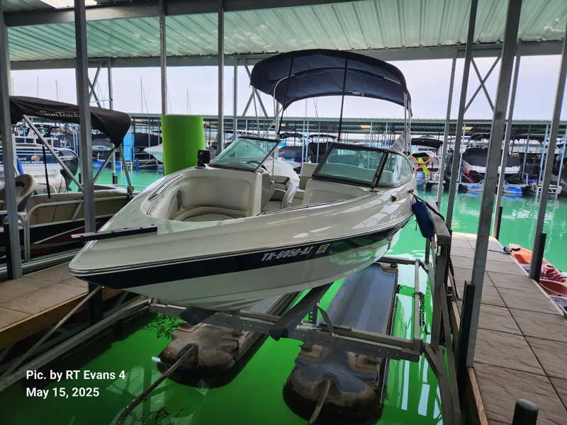 Slide: The Image of 2008 Caravelle 206LS Bow Rider boat docked in marina with canopy. - 1
