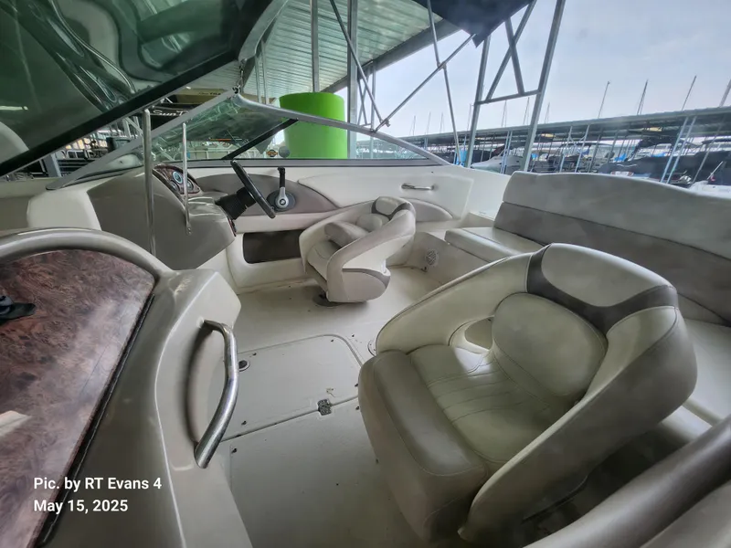 Slide: The Image of 2008 Caravelle 206LS Bow Rider interior with seating and steering wheel, docked at marina. - 10