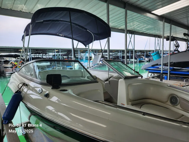 Slide: The Image of 2008 Caravelle 206LS Bow Rider boat docked under a covered marina. - 2