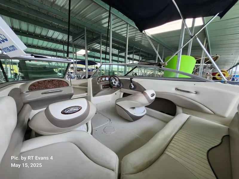 Slide: The Image of 2008 Caravelle 206LS Bow Rider interior under a metal canopy, showcasing seating and dashboard. - 8
