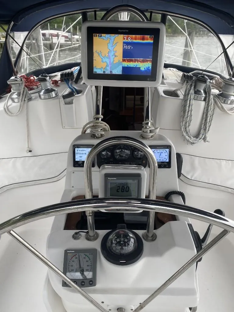 Slide: The Image of Cockpit of 2001 Hunter 410 sailboat with navigation equipment and steering wheel. - 10