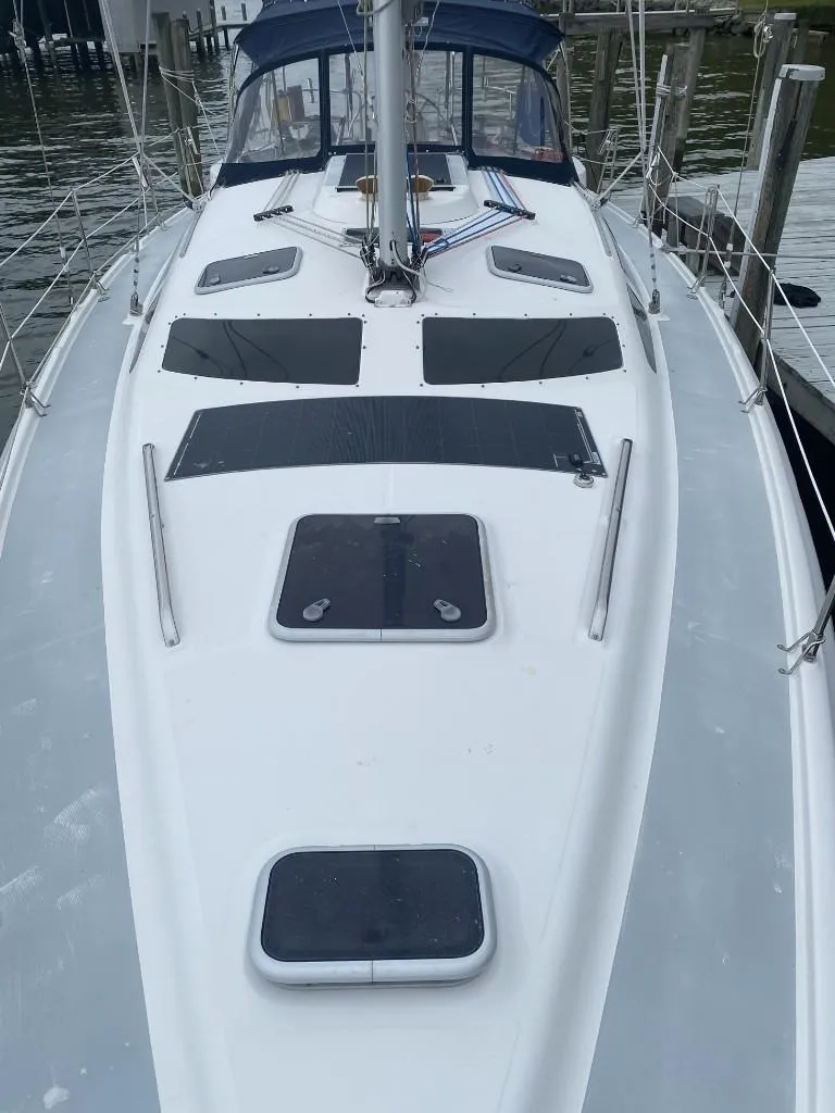 Slide: The Image of 2001 Hunter 410 sailboat deck with hatches and rigging, docked at marina. - 12