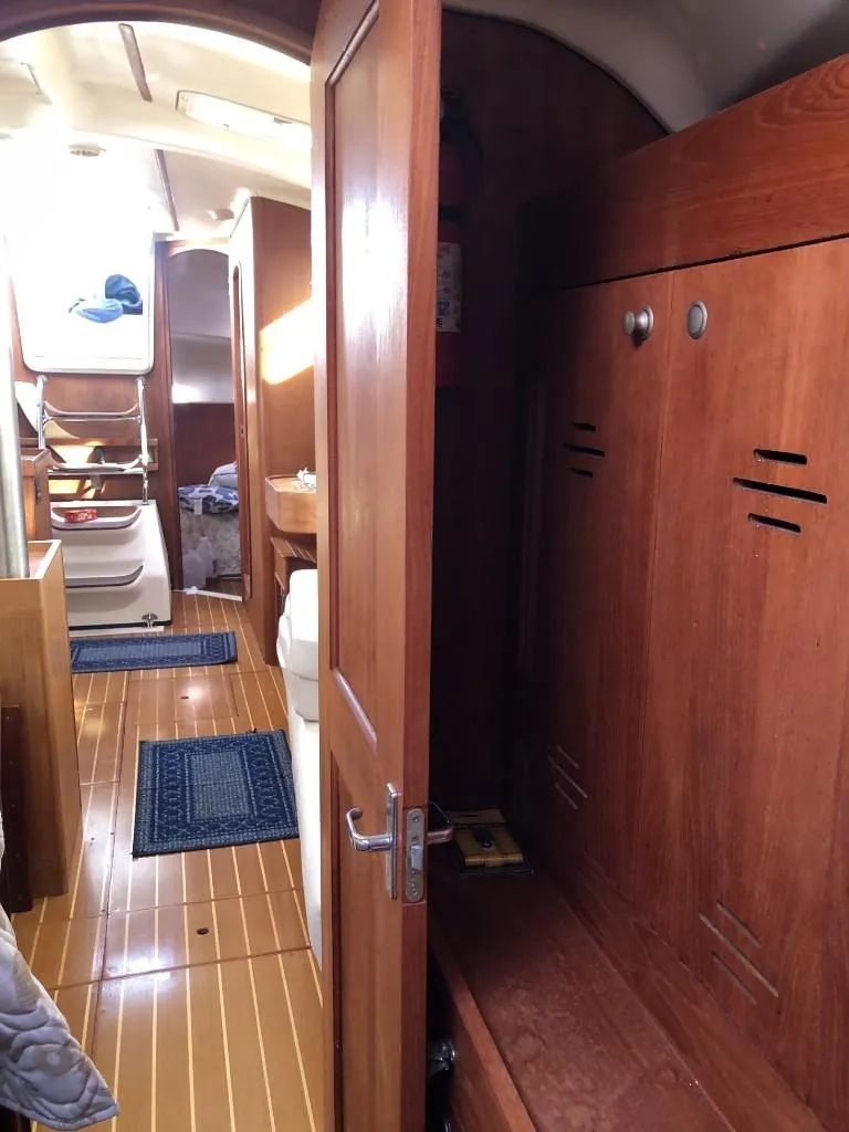 Slide: The Image of Interior of 2001 Hunter 410 sailboat with wooden cabinetry and flooring. - 15