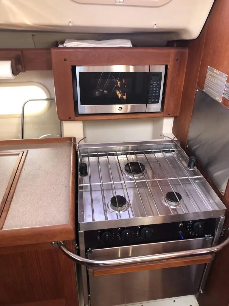 Slide: The Image of Compact kitchen in 2001 Hunter 410 yacht with stove and microwave. - 18