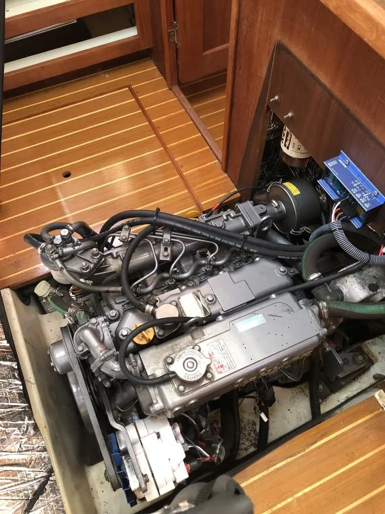 Slide: The Image of Engine of a 2001 Hunter 410 sailboat, showcasing detailed mechanical components. - 22