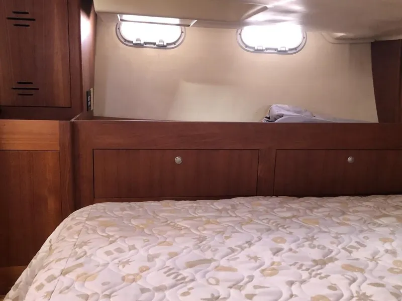 Slide: The Image of Cozy cabin interior of 2001 Hunter 410 sailboat with wooden storage and patterned bedding. - 23