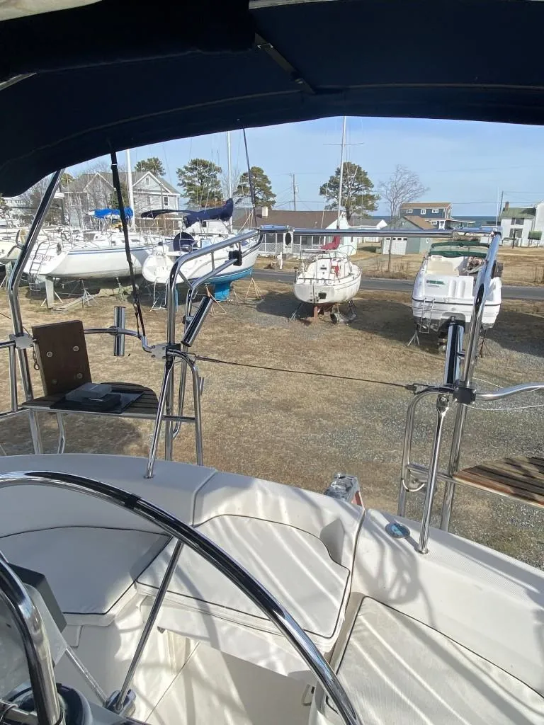 Slide: The Image of Hunter 410 sailboat cockpit view, 2001 model, in a marina with other boats. - 5