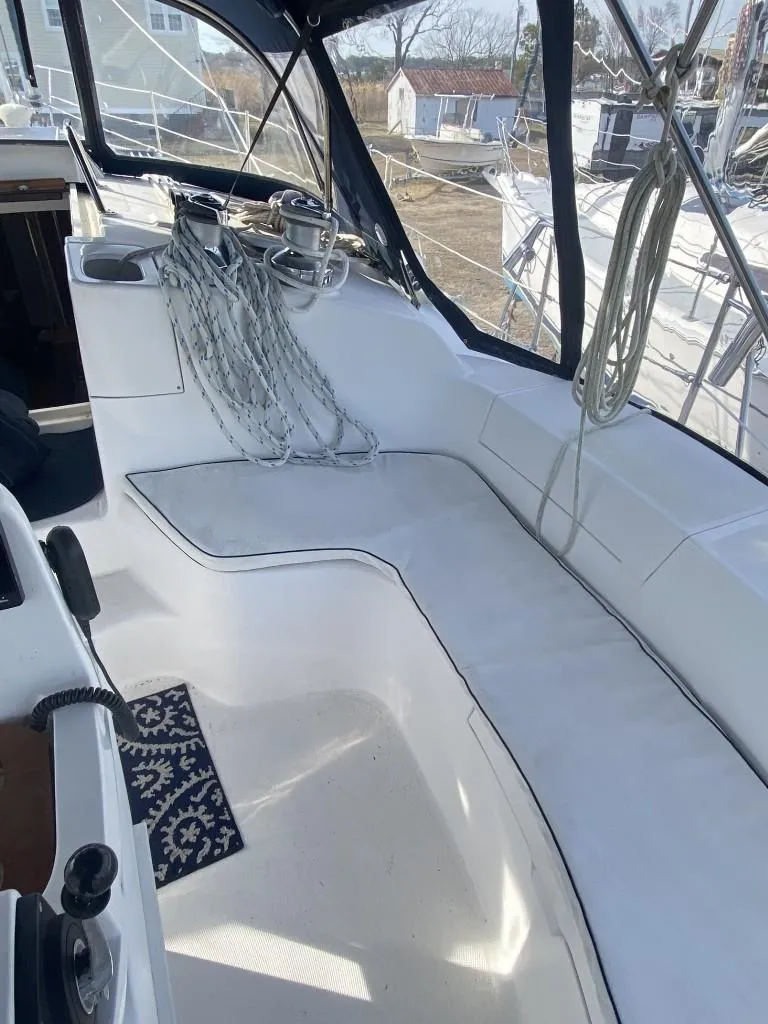 Slide: The Image of 2001 Hunter 410 sailboat cockpit with seating and rigging, featuring a clean, white interior. - 6