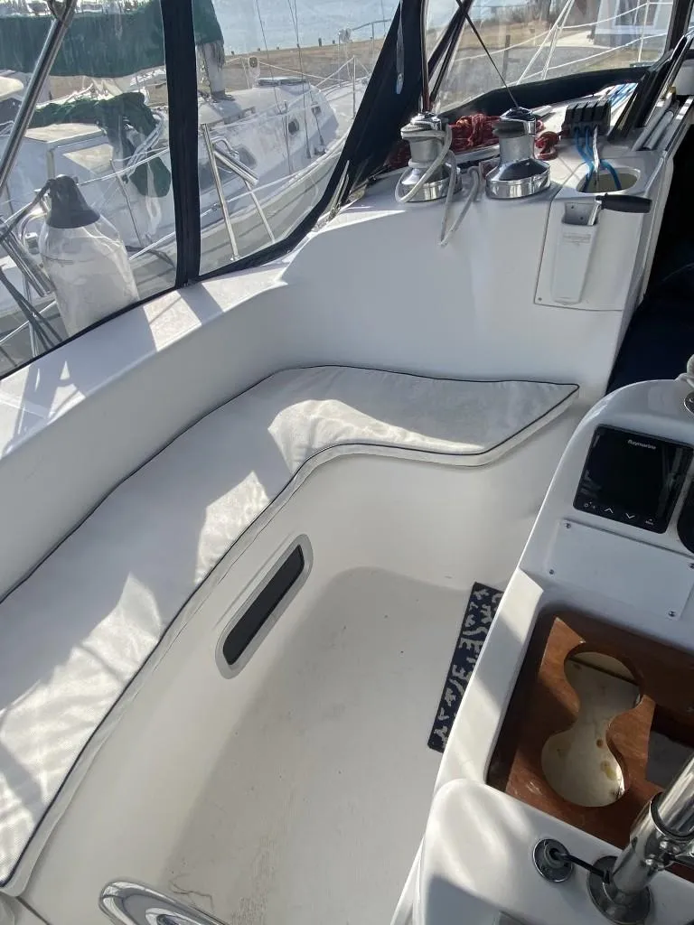 Slide: The Image of Cockpit of 2001 Hunter 410 sailboat with white seating and nautical equipment. - 7