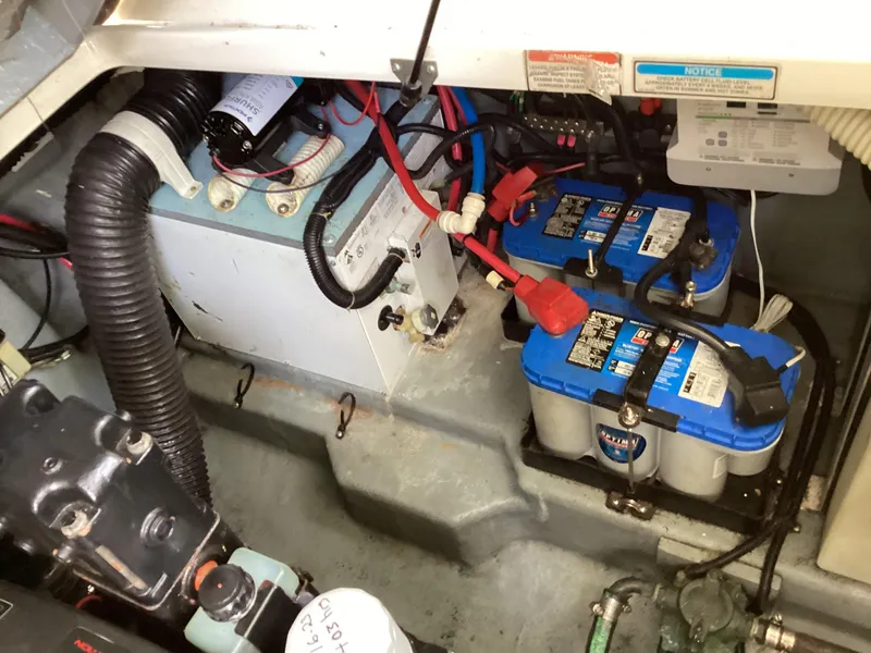 Slide: The Image of Engine compartment of a 2000 Sea Ray 270 Sundancer with batteries and wiring. - 12