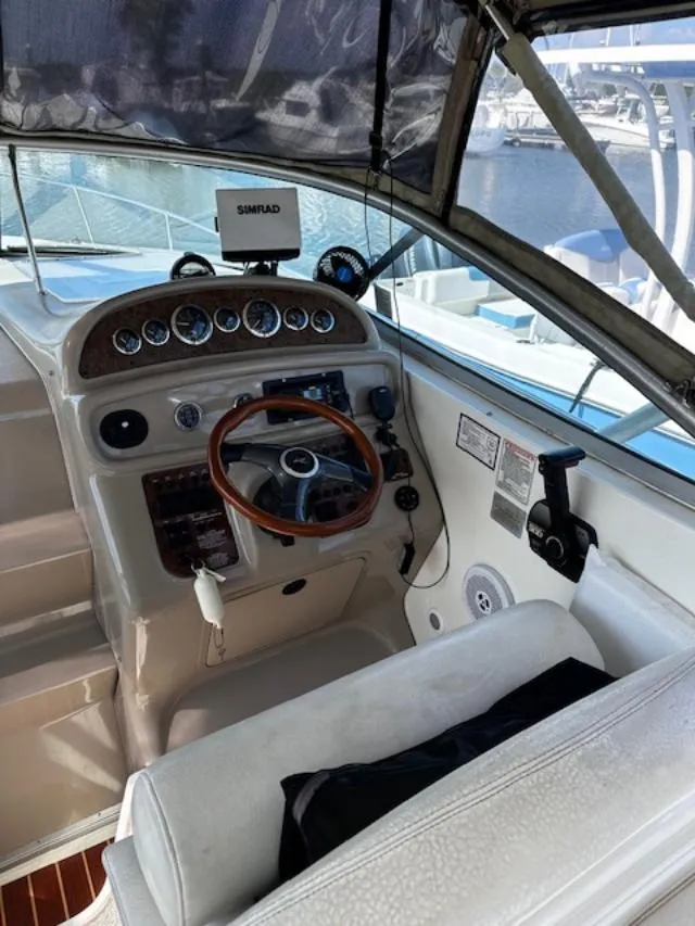 Slide: The Image of Cockpit of 2000 Sea Ray 270 Sundancer with steering wheel and navigation equipment. - 13