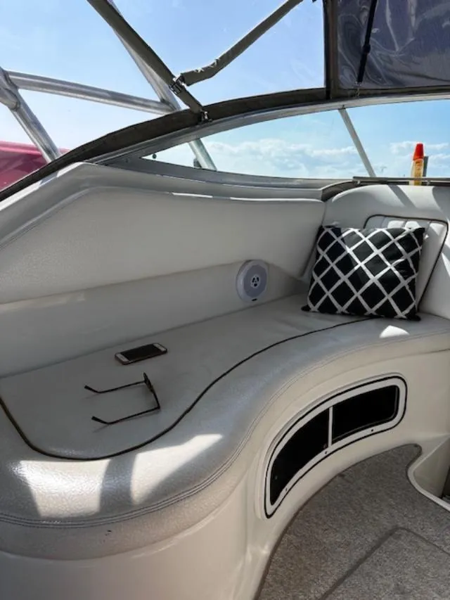 Slide: The Image of Interior of 2000 Sea Ray 270 Sundancer with seating, pillow, and personal items. - 15