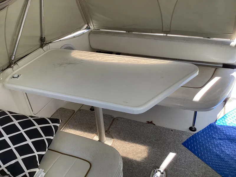 Slide: The Image of Interior of 2000 Sea Ray 270 Sundancer with table and seating area. - 16