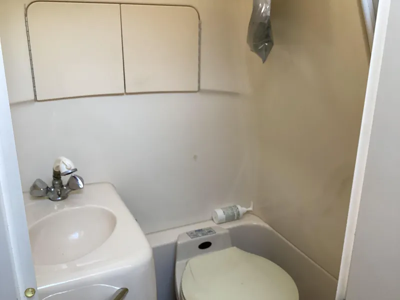 Slide: The Image of Compact bathroom in 2000 Sea Ray 270 Sundancer boat with sink and toilet. - 17