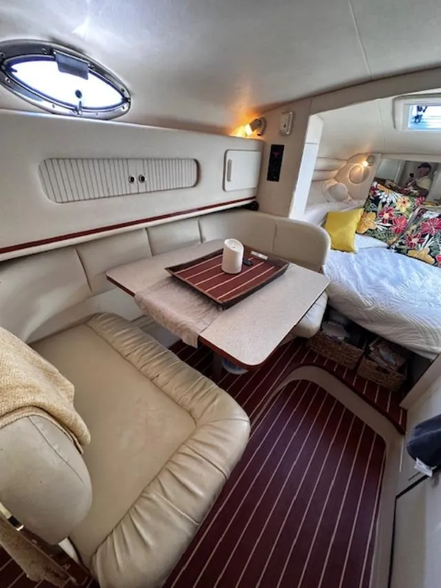 Slide: The Image of Interior of 2000 Sea Ray 270 Sundancer with cozy seating and bed area. - 19