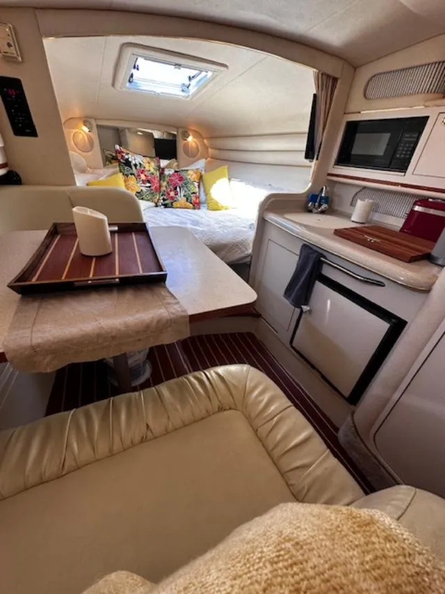 Slide: The Image of Interior of 2000 Sea Ray 270 Sundancer boat with cozy cabin and kitchenette. - 20