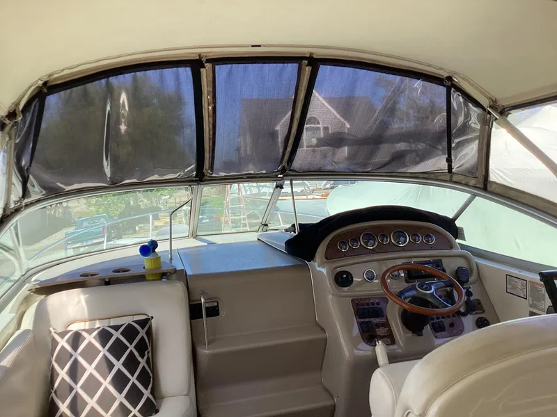 Slide: The Image of Interior view of 2000 Sea Ray 270 Sundancer boat cockpit with steering wheel and seating. - 5