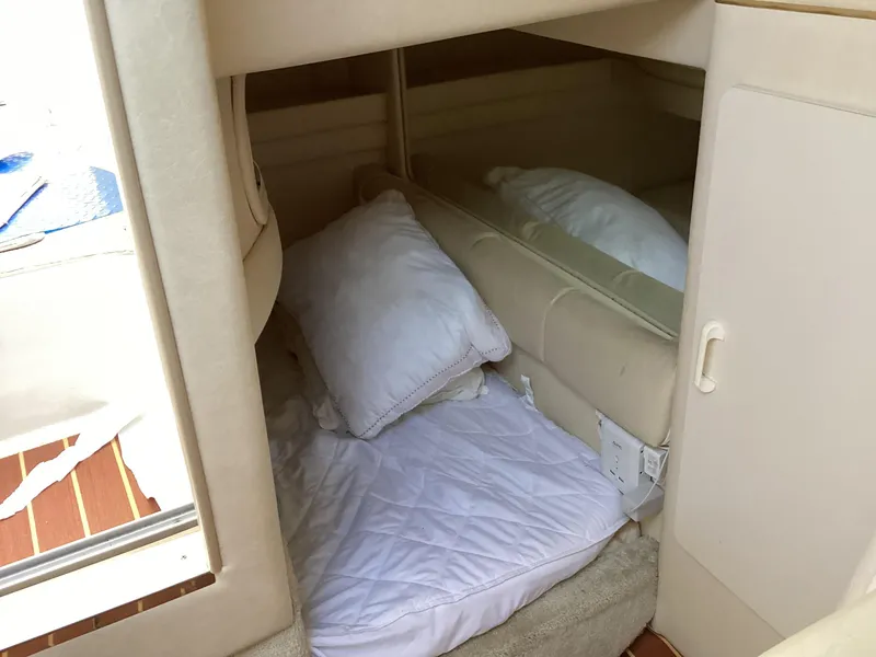 Slide: The Image of Cozy cabin interior of 2000 Sea Ray 270 Sundancer with bedding and pillows. - 6