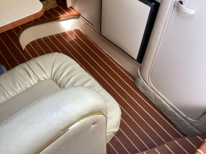 Slide: The Image of Interior of 2000 Sea Ray 270 Sundancer with leather seating and wood-patterned flooring. - 7