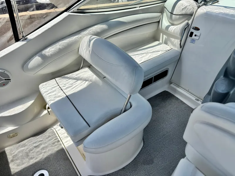 Slide: The Image of 2004 Maxum 2500 SE boat interior with white seating and carpeted floor. - 19
