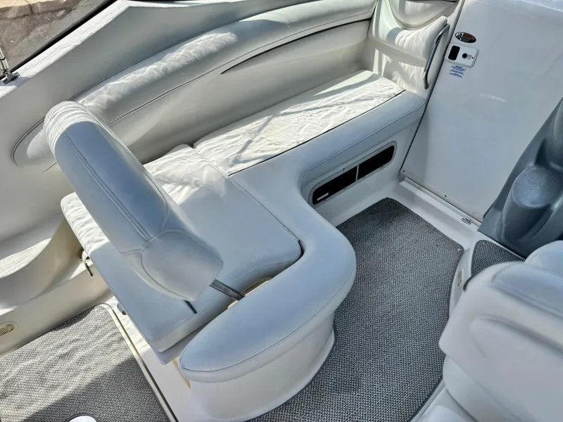 Slide: The Image of 2004 Maxum 2500 SE boat interior with white seating and carpeted floor. - 20