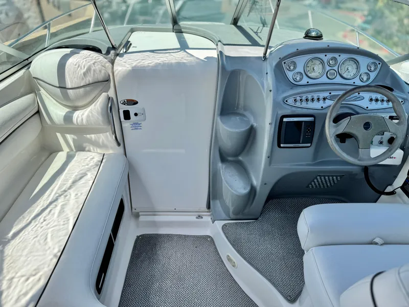 Slide: The Image of 2004 Maxum 2500 SE boat interior with steering wheel and dashboard controls. - 23