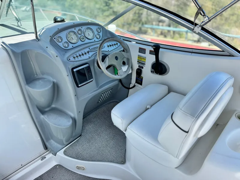 Slide: The Image of 2004 Maxum 2500 SE boat cockpit with steering wheel and control panel. - 24