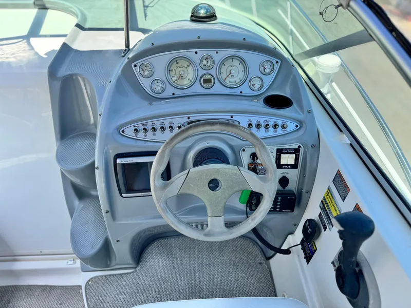 Slide: The Image of 2004 Maxum 2500 SE boat dashboard with steering wheel and instrument panel. - 25