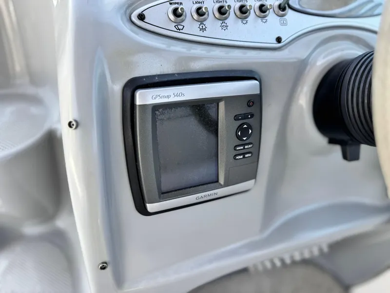 Slide: The Image of Garmin GPSmap 540s on 2004 Maxum 2500 SE boat dashboard, featuring control buttons and display. - 27
