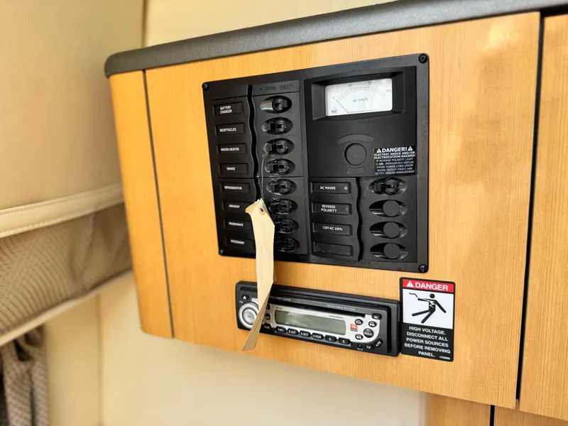 Slide: The Image of Electrical panel and radio in 2004 Maxum 2500 SE boat interior. - 38