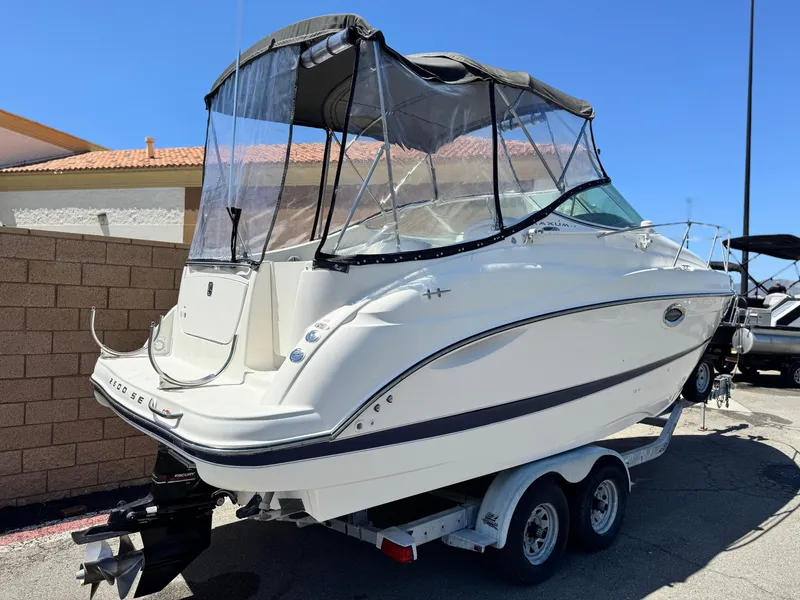 Slide: The Image of 2004 Maxum 2500 SE boat on trailer, featuring a canopy and sleek design. - 5