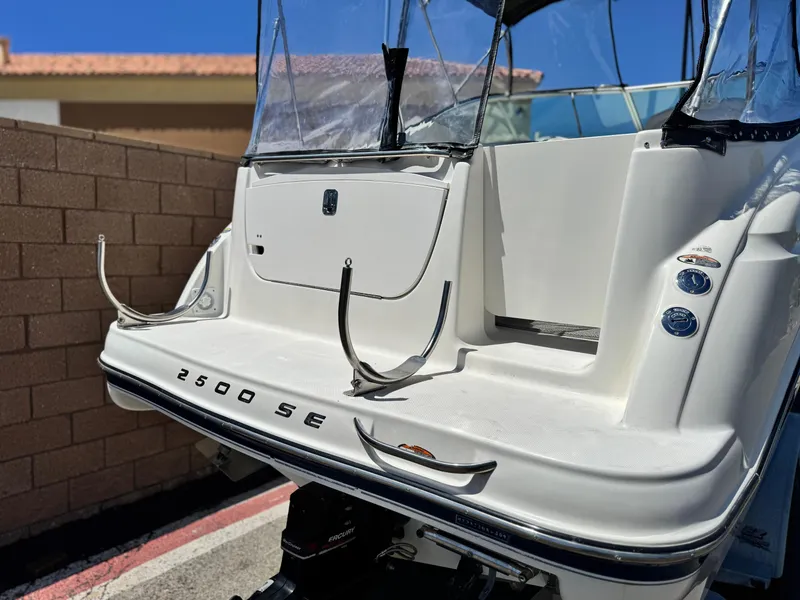 Slide: The Image of 2004 Maxum 2500 SE boat stern view with clear canopy and sleek design. - 6