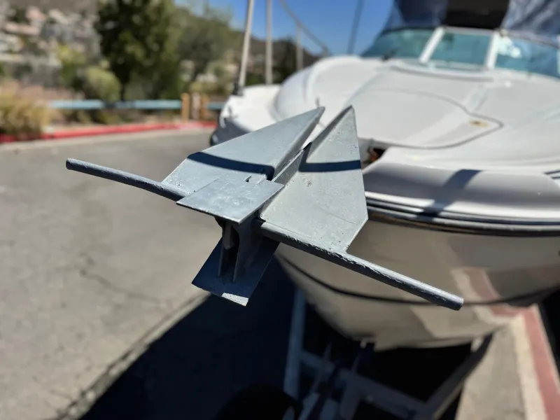 Slide: The Image of 2004 Maxum 2500 SE boat with anchor, parked on a trailer. - 8