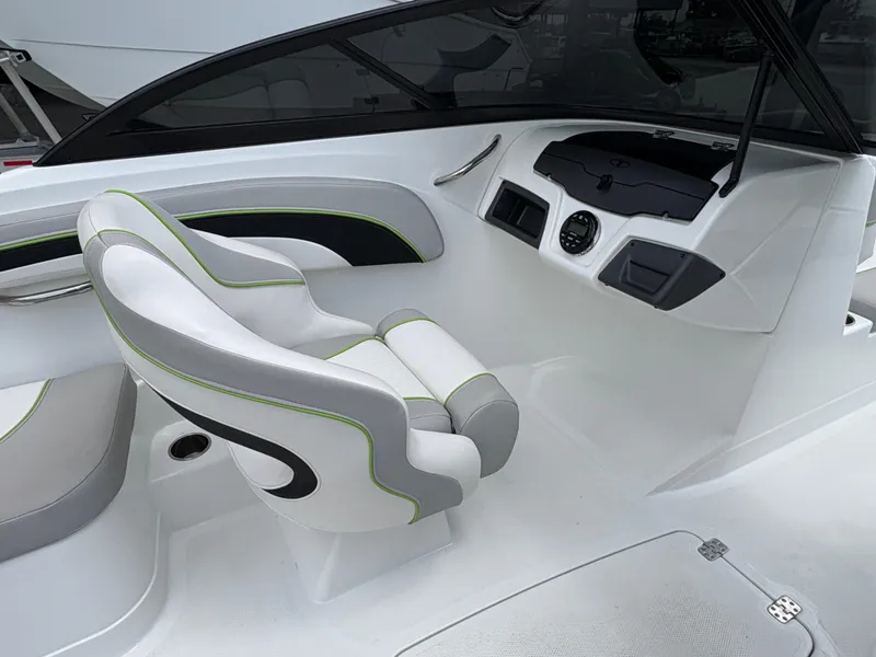 Slide: The Image of 2019 Tahoe 700 boat interior with modern white and green seating and sleek dashboard design. - 10
