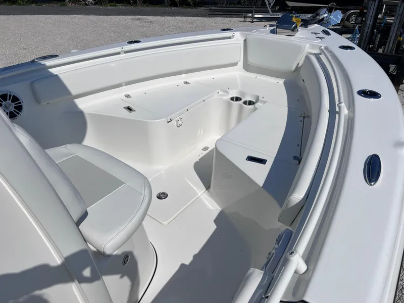 Slide: The Image of 2025 Key West 239FSR boat interior with white seating and storage compartments. - 12