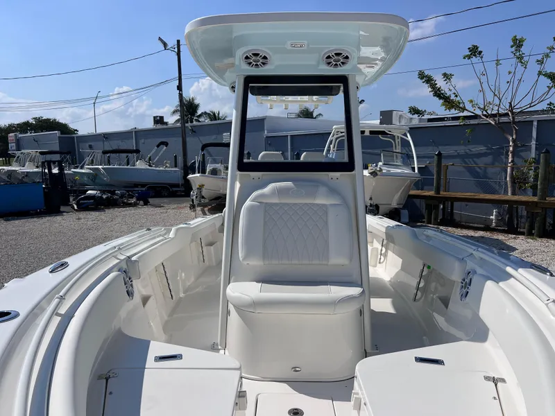 Slide: The Image of 2025 Key West 239FSR boat, white interior, docked outdoors under clear sky. - 16