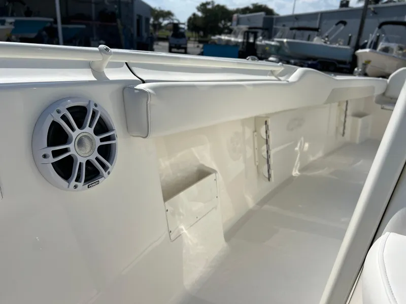 Slide: The Image of 2025 Key West 239FSR boat interior with speaker, white seating, and sleek design. - 18