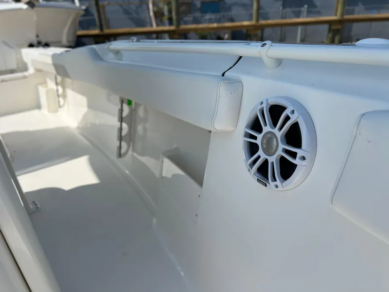Slide: The Image of 2025 Key West 239FSR boat interior with speaker detail, showcasing sleek white design. - 19