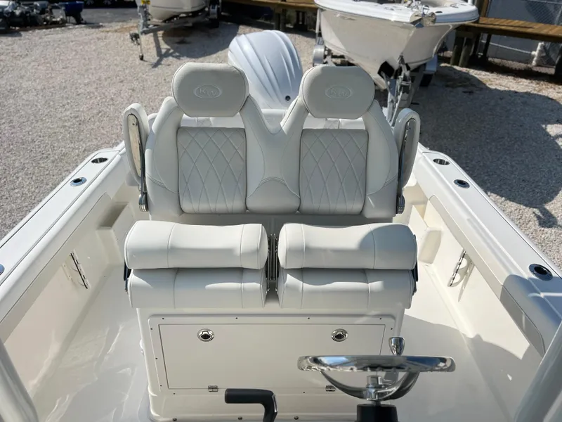 Slide: The Image of 2025 Key West 239FSR boat interior with dual cushioned seats and steering wheel. - 26